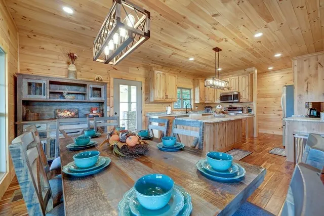 a kitchen with stainless steel appliances kitchen island granite countertop a sink and cabinets