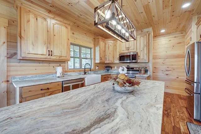 a kitchen with stainless steel appliances granite countertop a stove and a sink