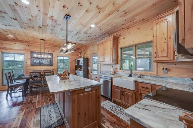 a large kitchen with lots of counter space and painting on the wall