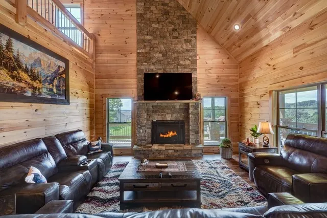 a living room with furniture a flat screen tv and a fireplace