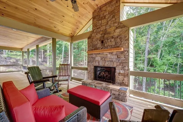 a living room with furniture a large window and a fireplace