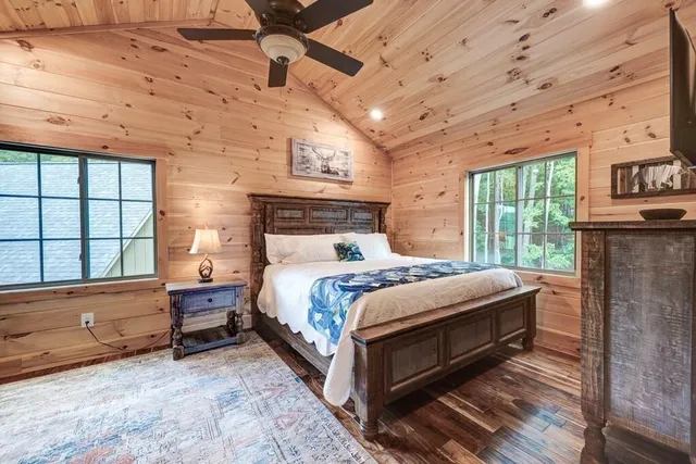 a bedroom with a bed and large window