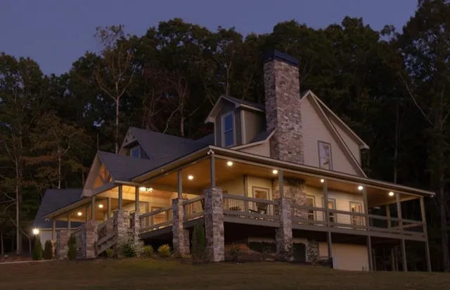 a roof deck with table and chairs under an umbrella