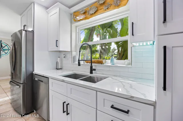 a kitchen with stainless steel appliances granite countertop a sink and a window