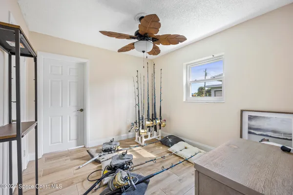 a living room with furniture a window and a chandelier