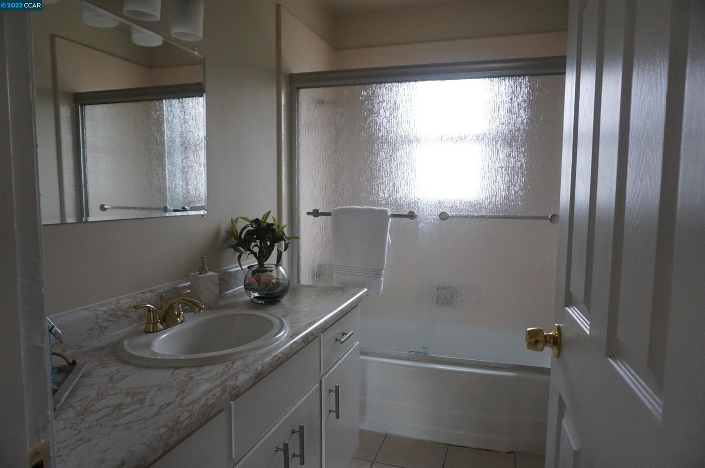 44 Anson Way Kensington, CA 94707 - Photo 18 of 22 a bathroom with a sink and a mirror