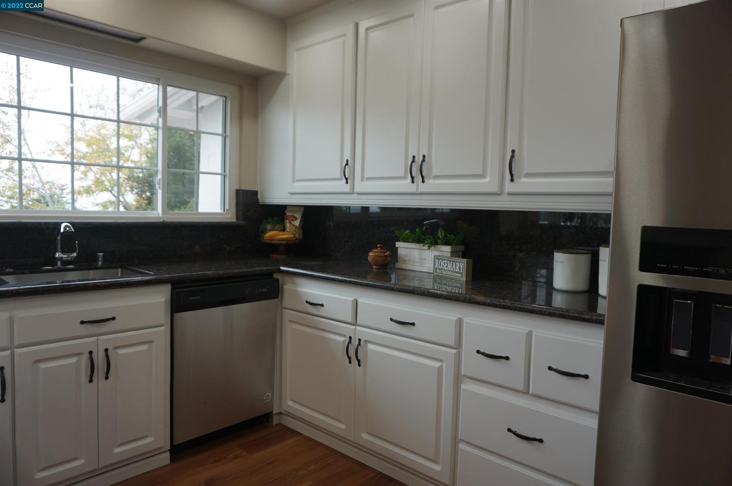 44 Anson Way Kensington, CA 94707 - Photo 10 of 22 a kitchen with granite countertop white cabinets and sink