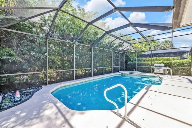 a view of a swimming pool with a patio and a yard