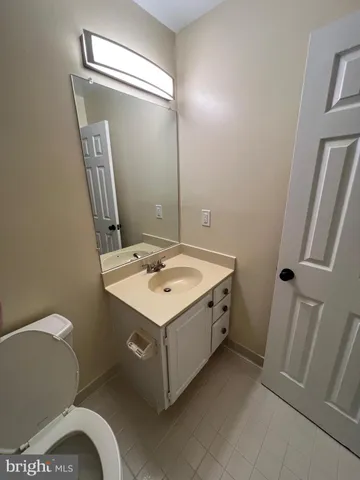 a bathroom with a sink mirror vanity and toilet