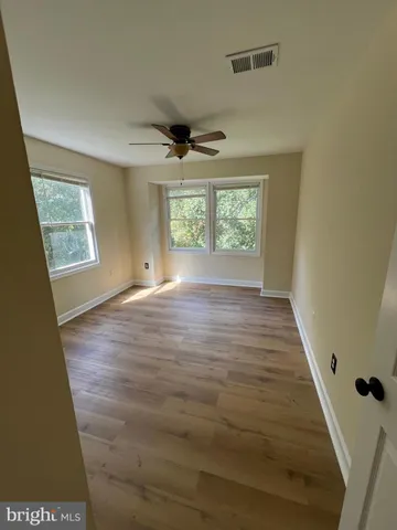 a view of an empty room with windows