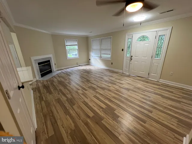 a view of a livingroom with wooden floor and window