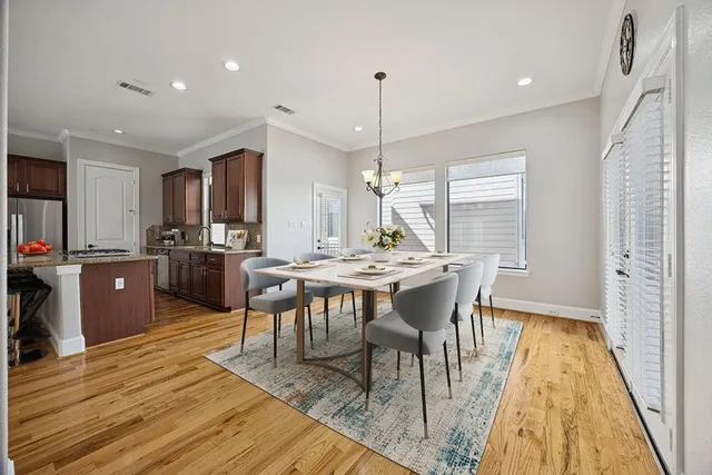 a view of a dining room with furniture window and wooden floor