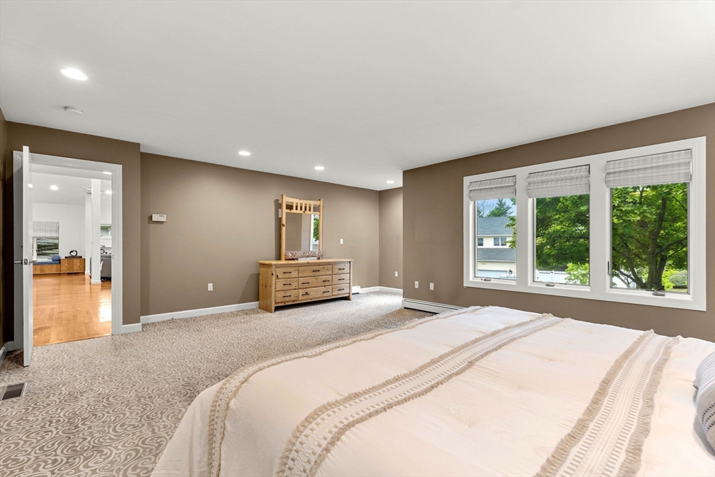 53 Gerald Road Marblehead, MA 01945 - Photo 14 of 42 a spacious bedroom with a large bed and a large window