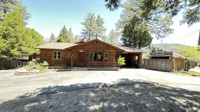 a front view of a house with a yard covered with snow in front of house
