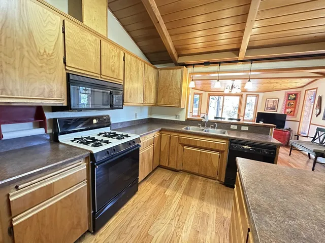 a bathroom with a granite countertop sink a toilet and shower