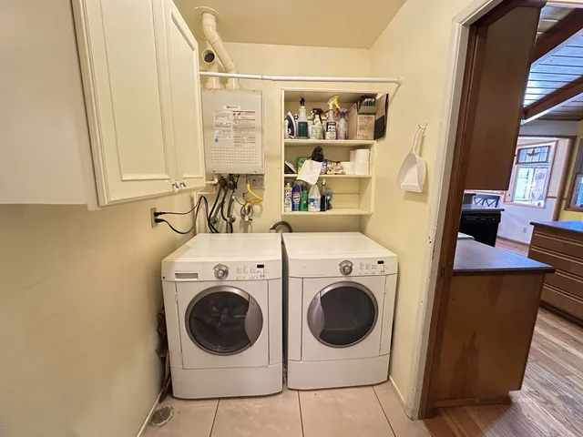 a view of patio with a table and chairs under an umbrella