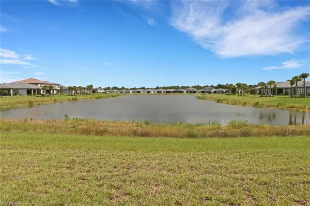 a view of a lake with houses in the back
