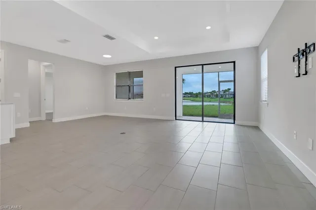 a kitchen with cabinets and chairs