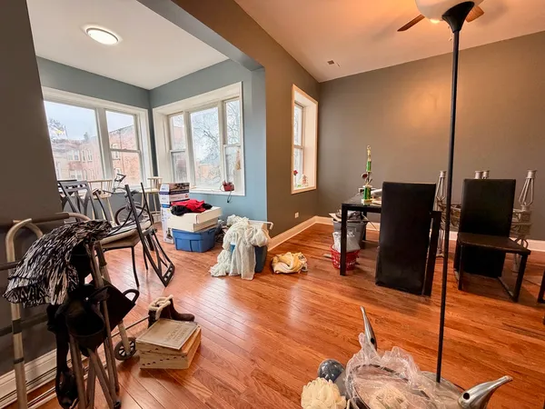a living room filled with furniture and floor to ceiling windows