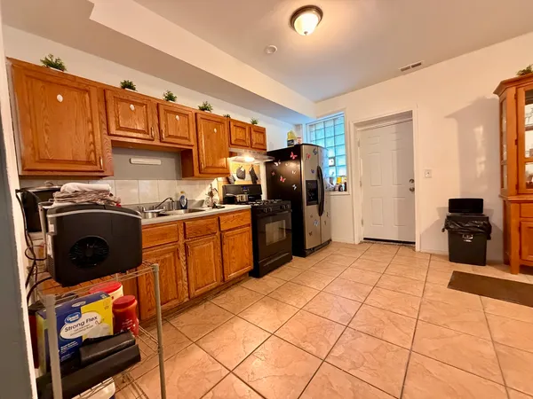 a kitchen with stainless steel appliances granite countertop a stove refrigerator sink and cabinets