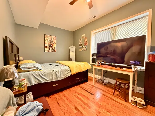a bedroom with a bed and a flat screen tv