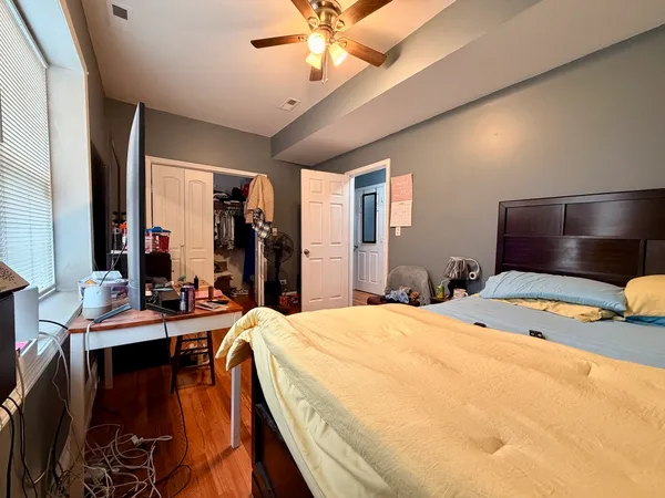 a bed room with a bed mirror and a chandelier