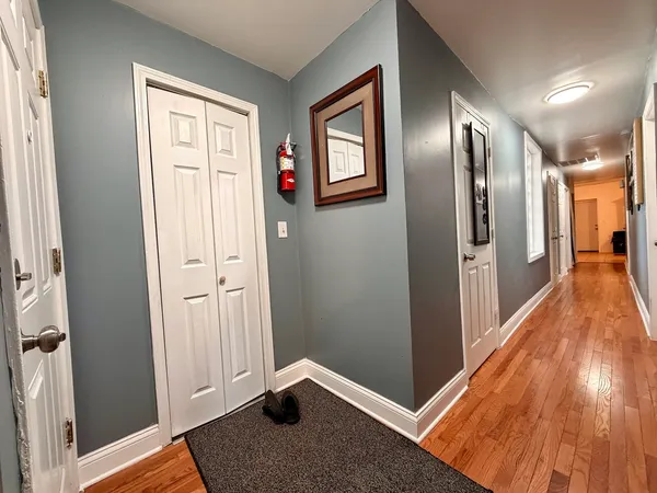 a view of hallway with wooden floor and stairs