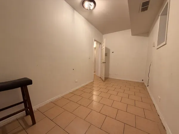 a view of an empty room and wooden floor