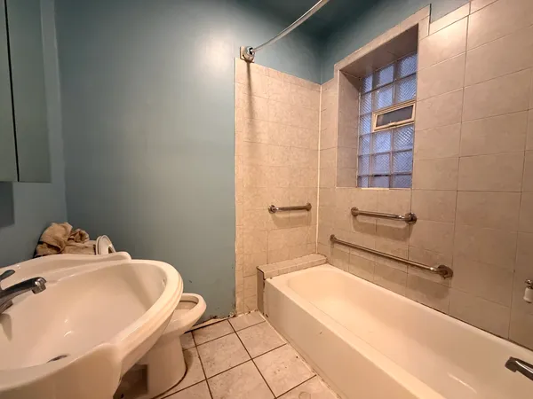 a bathroom with a bathtub and sink