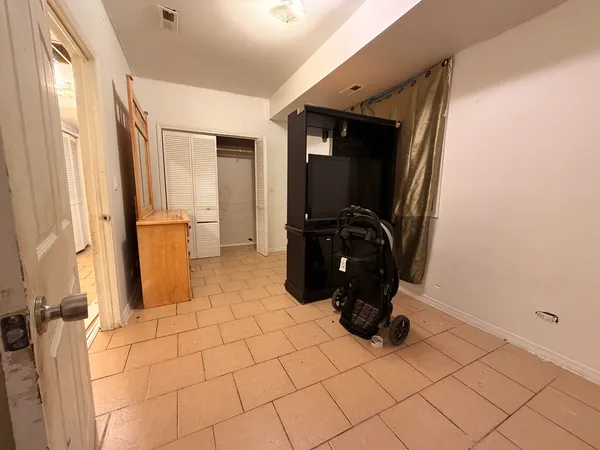 a view of a kitchen with an empty space and a window