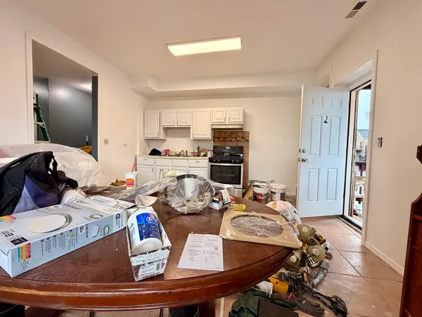 a view of a workspace with furniture and a window