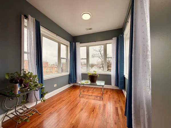 a very nice looking room with a large window and wooden floor