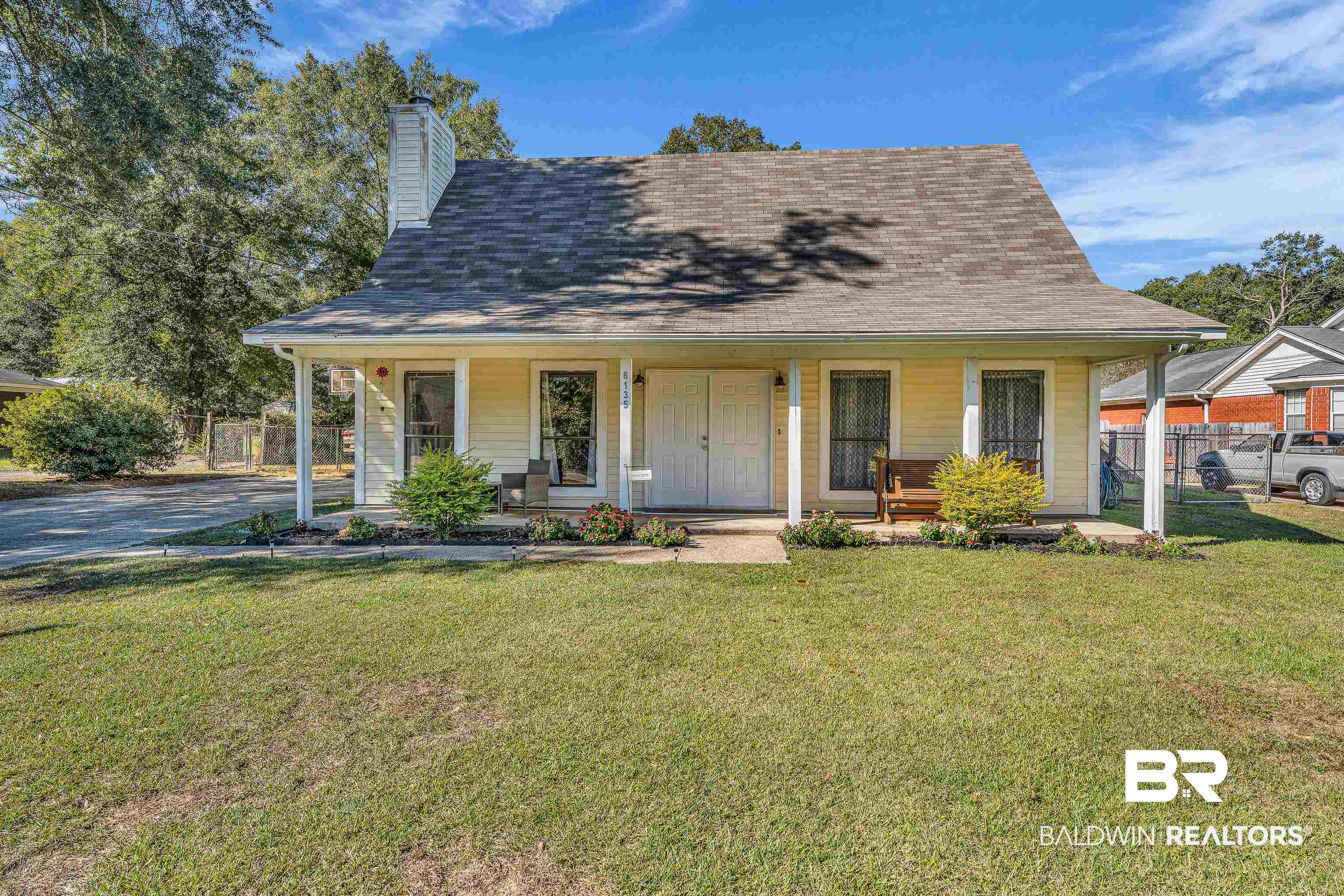 6135 Oak Cliff Drive Eight Mile, AL 36613 - Photo 2 of 30 Farmhouse-style home with a porch, a shingled roof, and a chimney