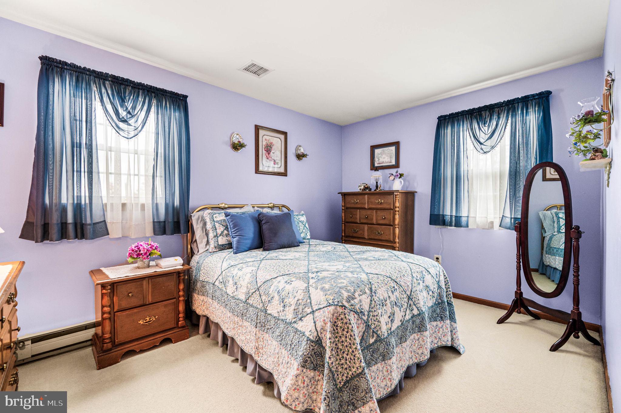 1548 County Line Road Bechtelsville, PA 19505 - Photo 15 of 31 a bedroom with a bed and dresser with mirror