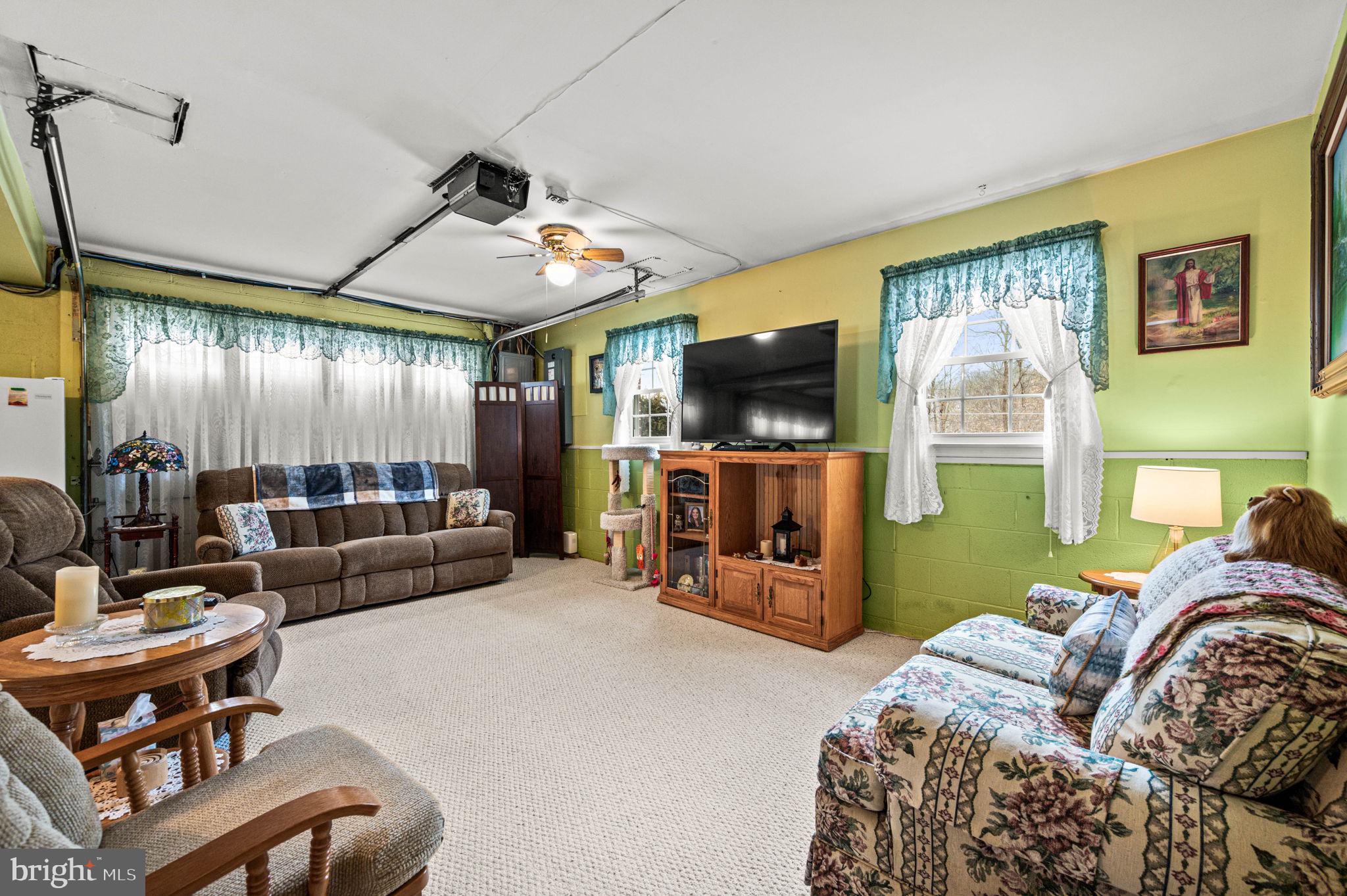 1548 County Line Road Bechtelsville, PA 19505 - Photo 22 of 31 a living room with furniture and a flat screen tv