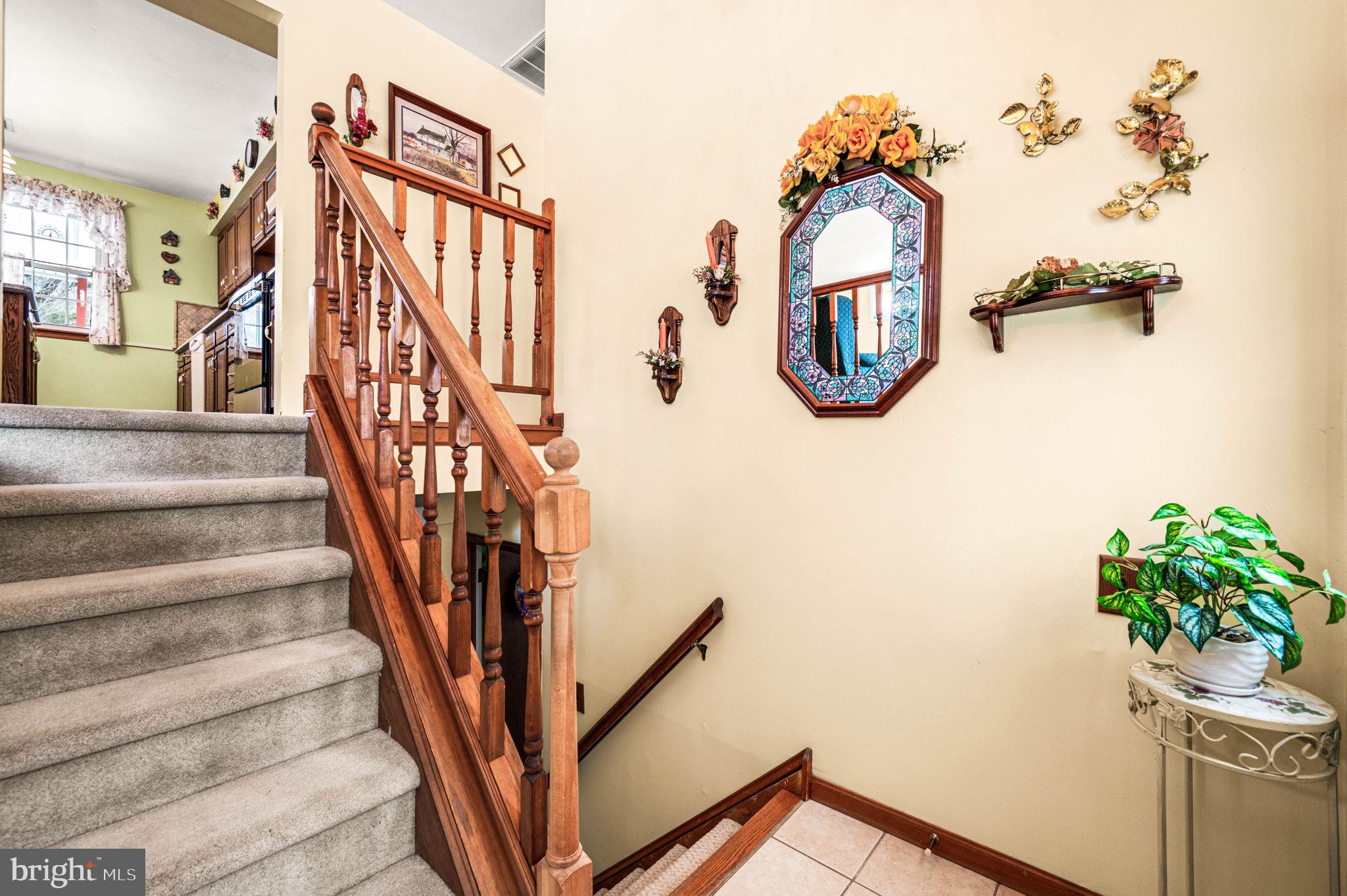1548 County Line Road Bechtelsville, PA 19505 - Photo 3 of 31 a view of staircase with lots of frames on wall and a wooden floor
