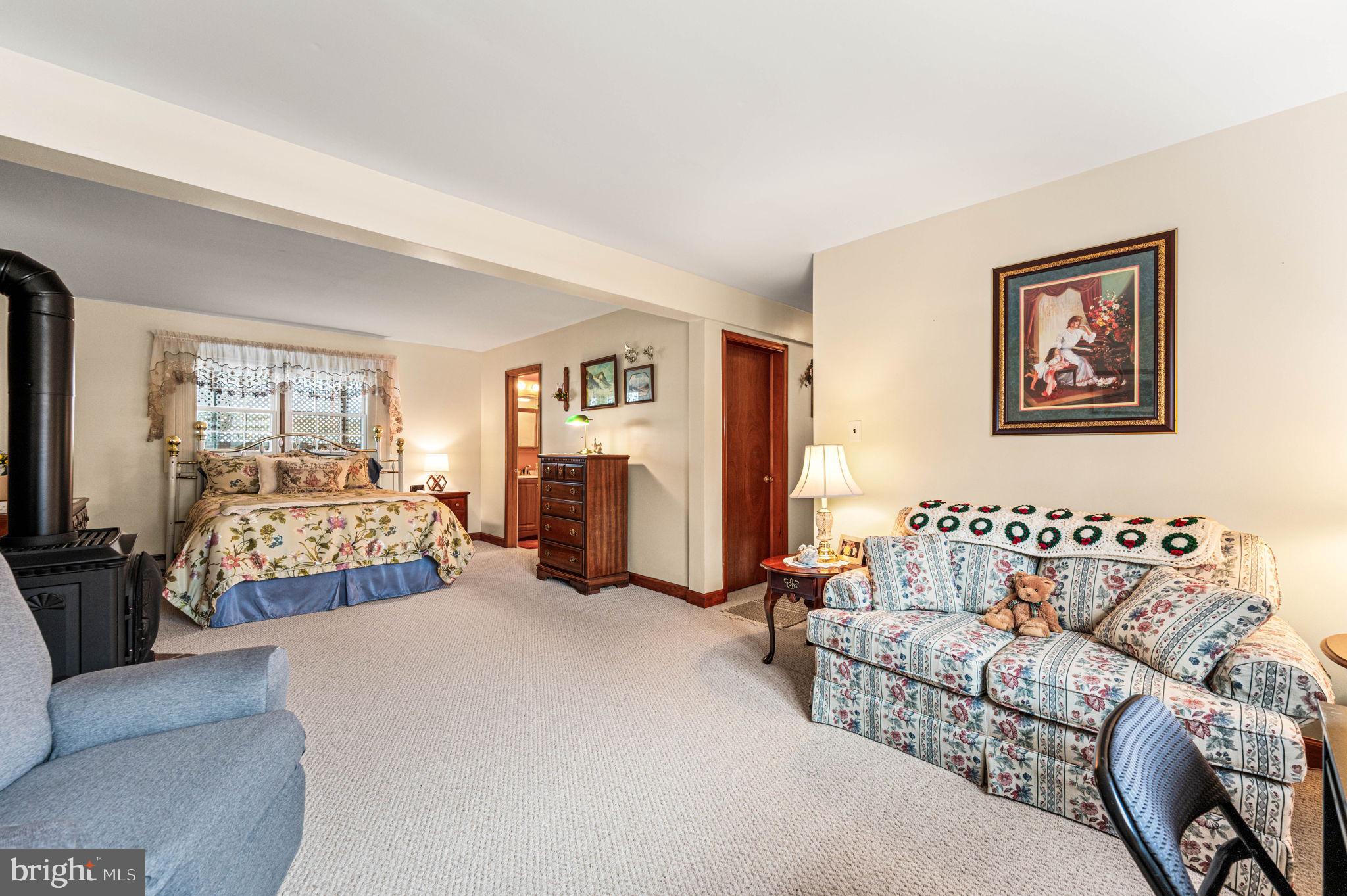 1548 County Line Road Bechtelsville, PA 19505 - Photo 7 of 31 a bedroom with furniture and a couch