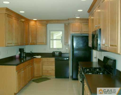 16 Dayton Road Edison, NJ 08817 - Photo 2 of 8 a kitchen with stainless steel appliances granite countertop a refrigerator a stove and a sink