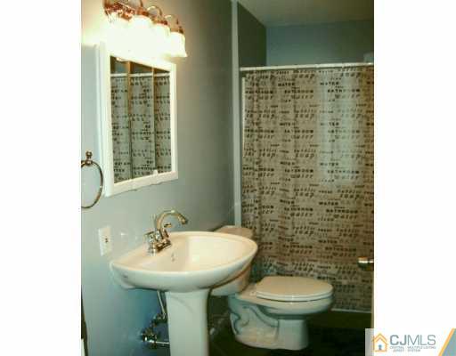 16 Dayton Road Edison, NJ 08817 - Photo 5 of 8 a bathroom with a sink a toilet and mirror