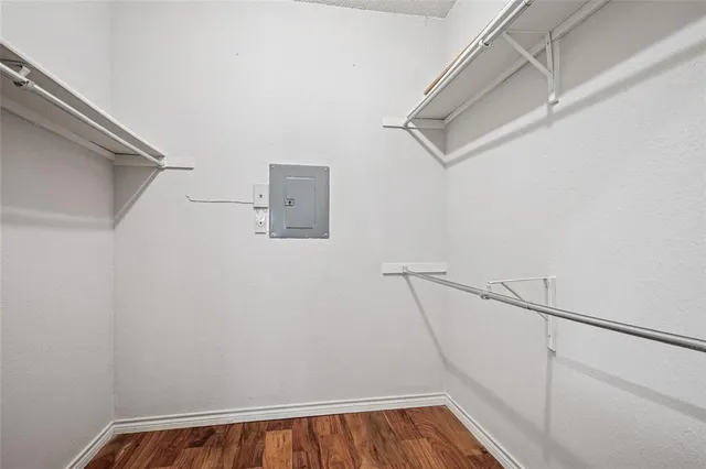 a view of walk in closet with empty racks