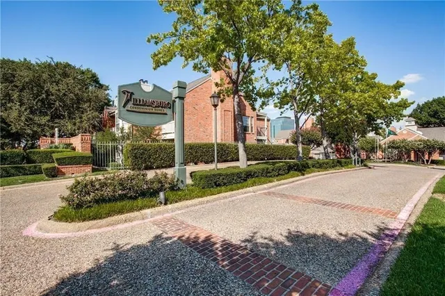 a front view of a house with a yard and a garden