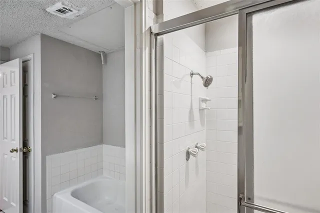 a bathroom with a glass shower door
