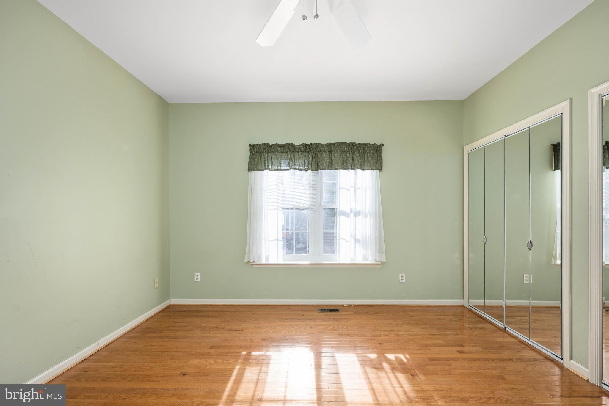 703 Yorktown Boulevard Locust Grove, VA 22508 - Photo 18 of 75 a view of an empty room with wooden floor and a window