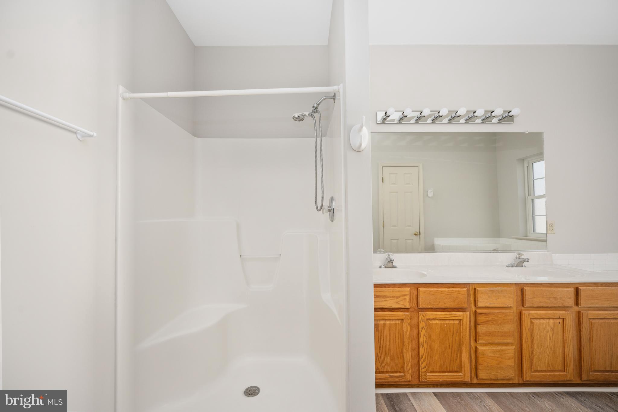 703 Yorktown Boulevard Locust Grove, VA 22508 - Photo 30 of 75 a bathroom with a granite countertop sink mirror and a bathtub