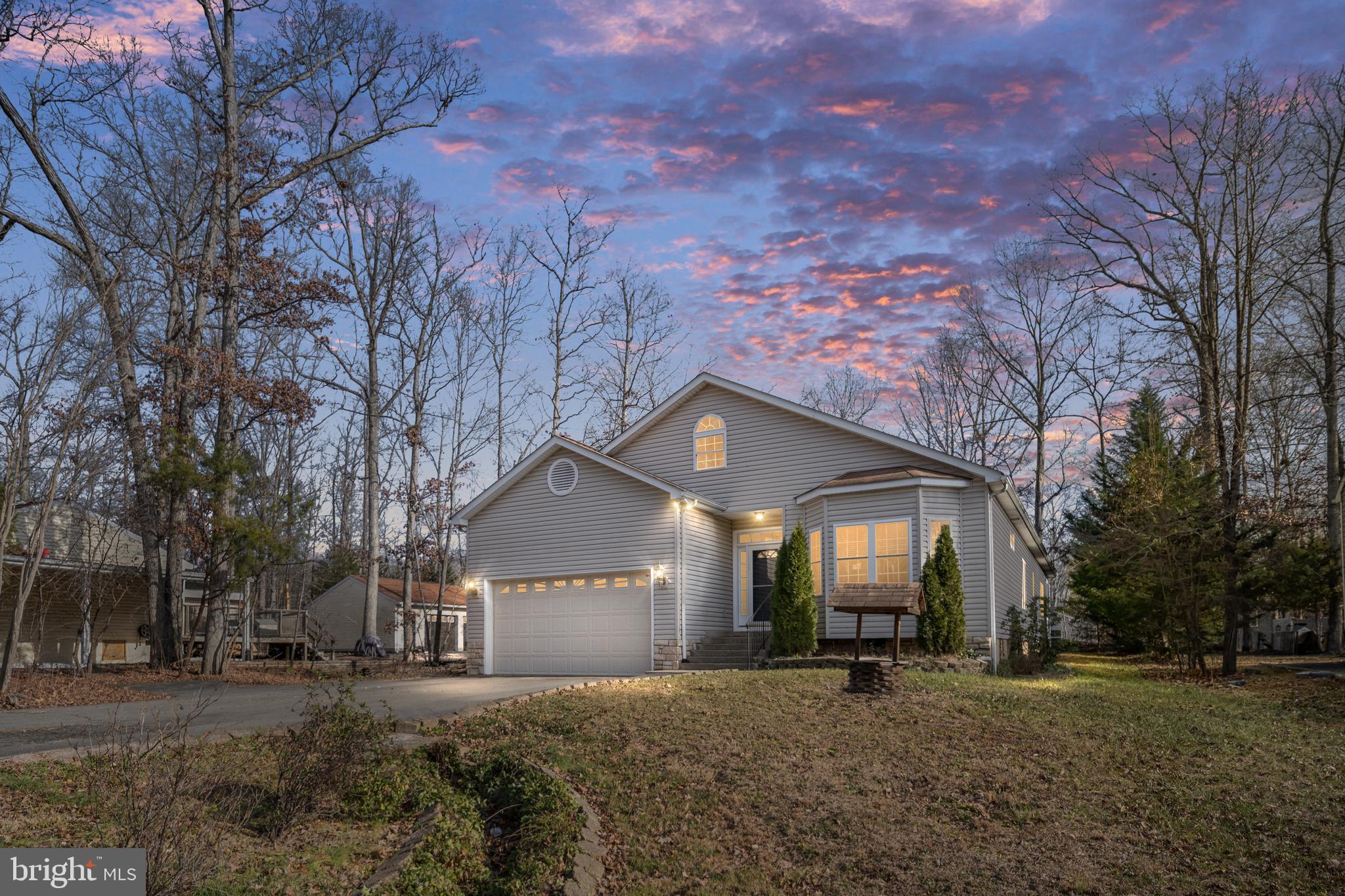 703 Yorktown Boulevard Locust Grove, VA 22508 - Photo 3 of 75 a front view of a house with a yard and garage