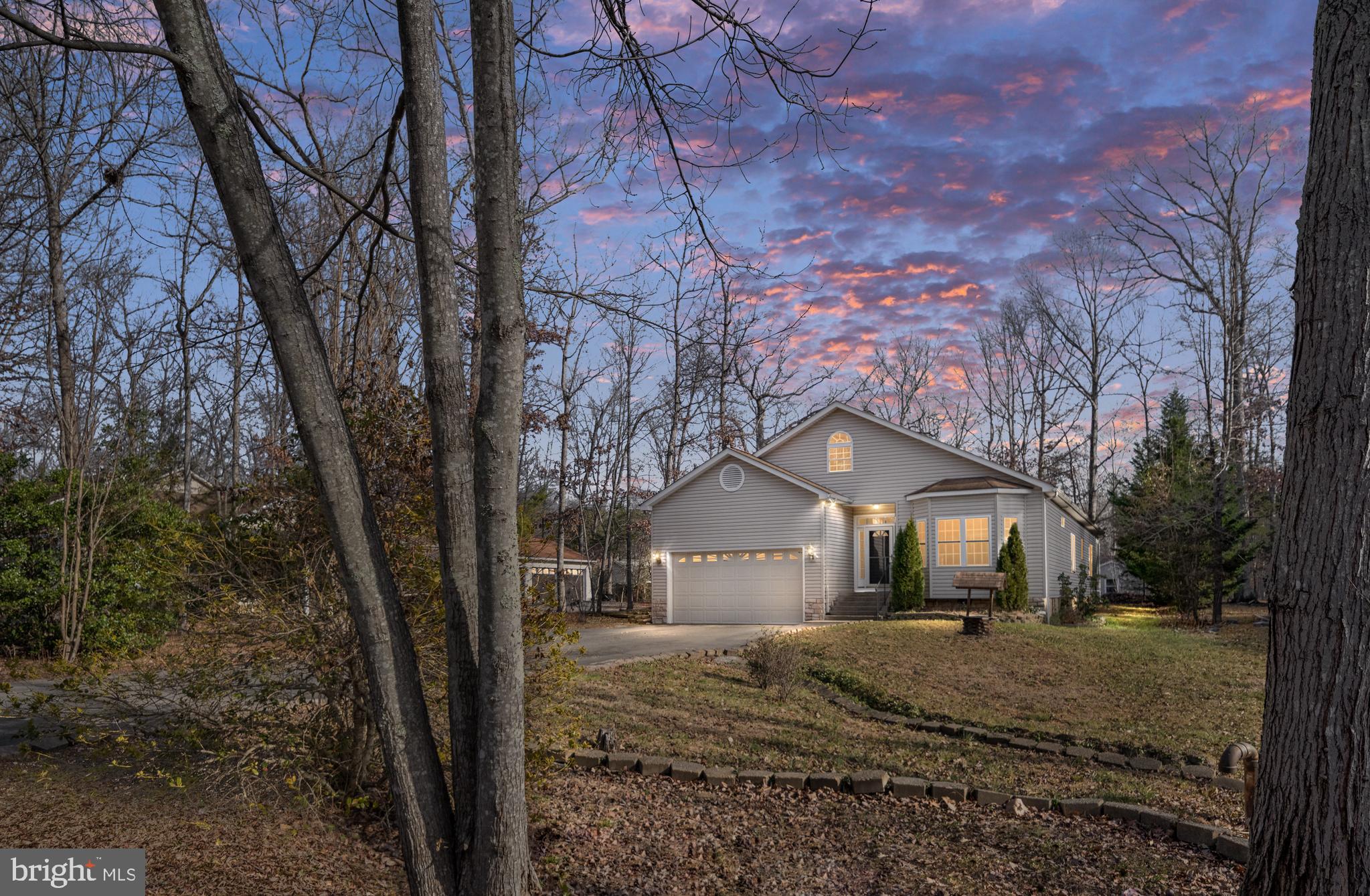 703 Yorktown Boulevard Locust Grove, VA 22508 - Photo 4 of 75 a front view of a house with a yard and large trees