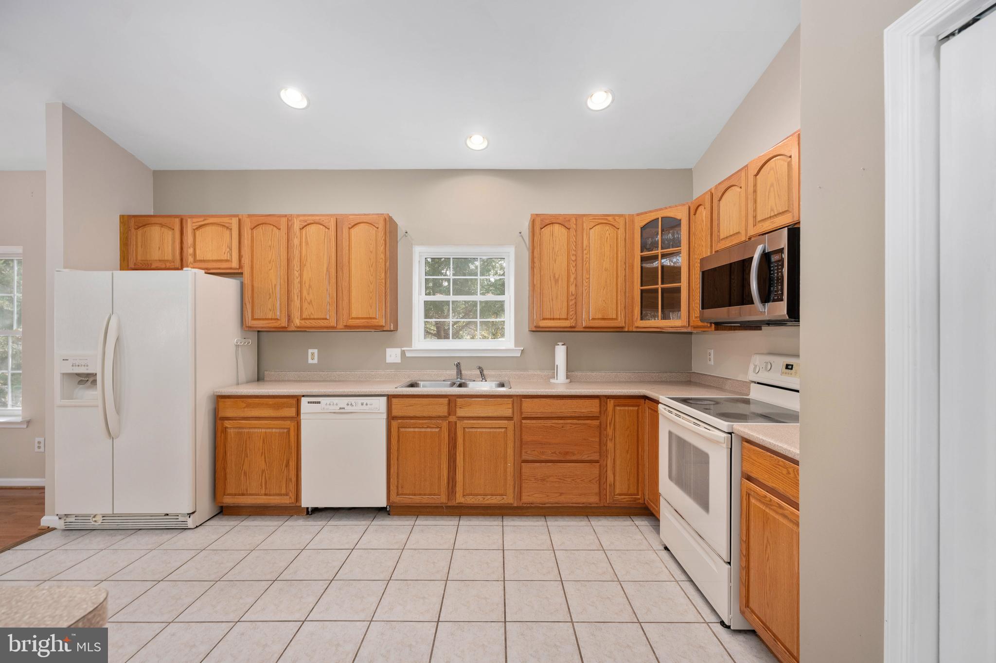 703 Yorktown Boulevard Locust Grove, VA 22508 - Photo 45 of 75 a kitchen with stainless steel appliances granite countertop a sink and cabinets