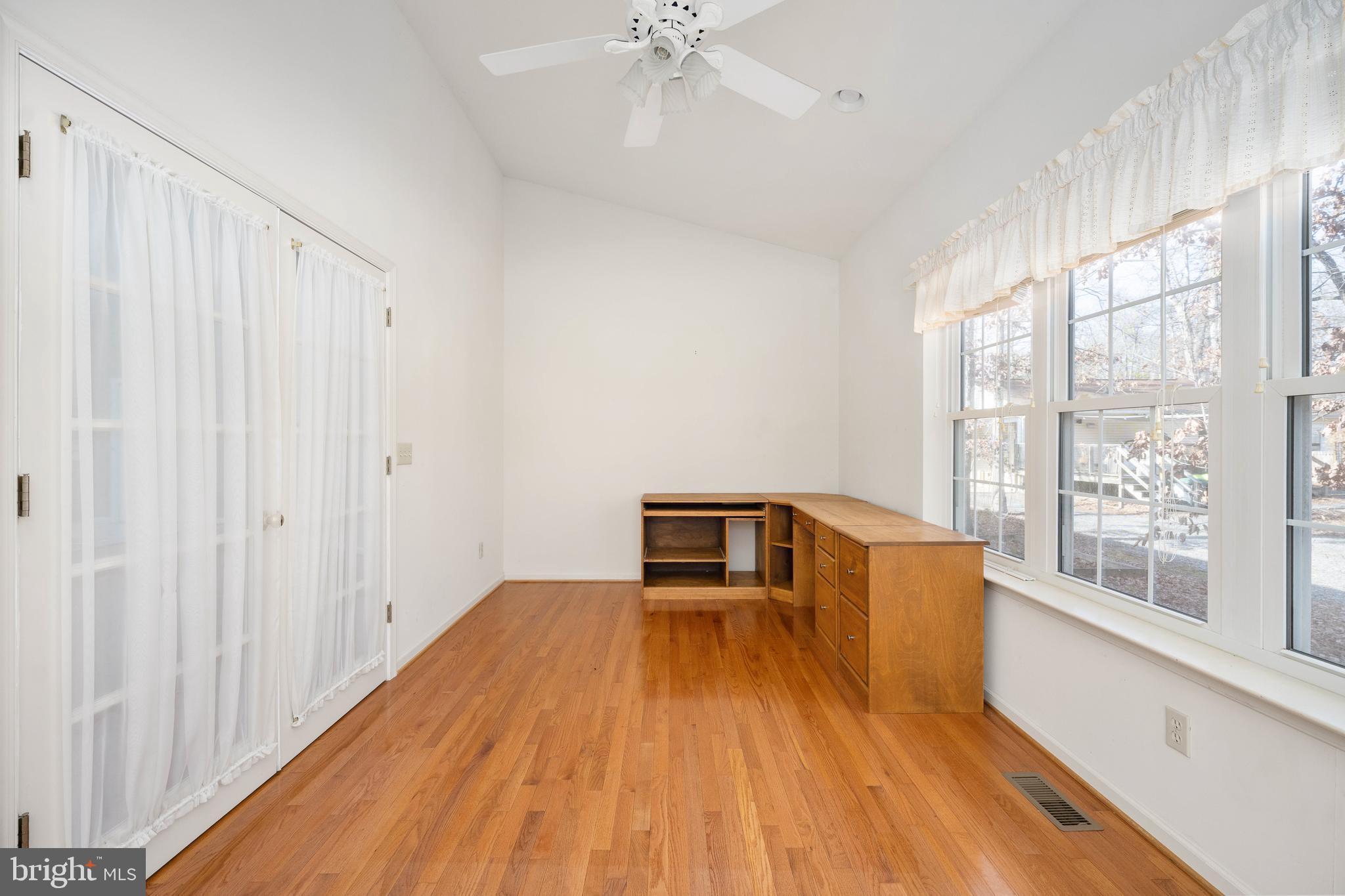 703 Yorktown Boulevard Locust Grove, VA 22508 - Photo 49 of 75 a big room with wooden floor a chandelier fan and windows