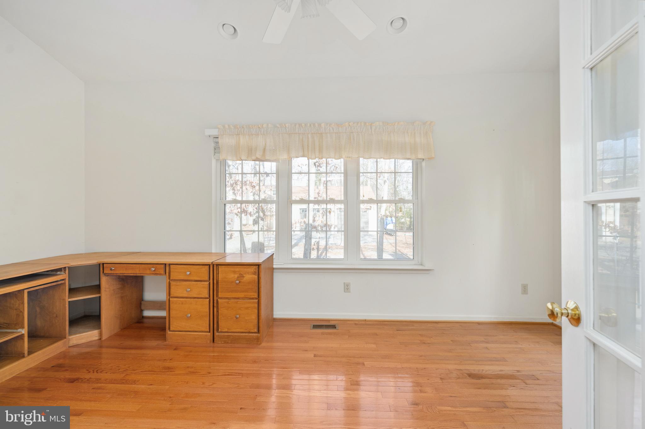 703 Yorktown Boulevard Locust Grove, VA 22508 - Photo 51 of 75 a view of an empty room with wooden floor and a window
