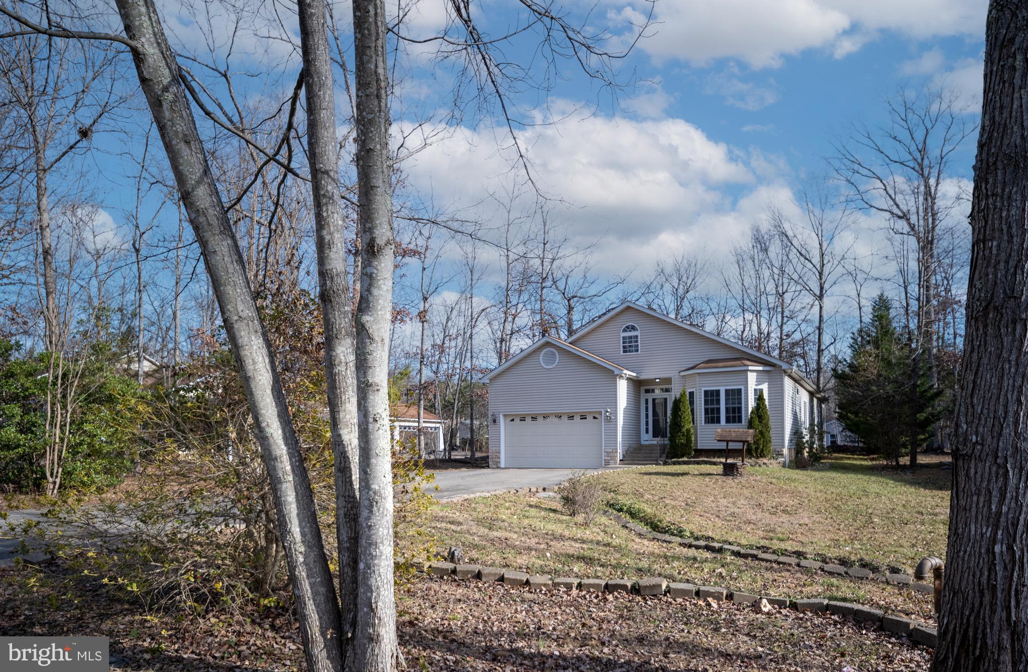 703 Yorktown Boulevard Locust Grove, VA 22508 - Photo 70 of 75 a front view of a house with a yard and large trees